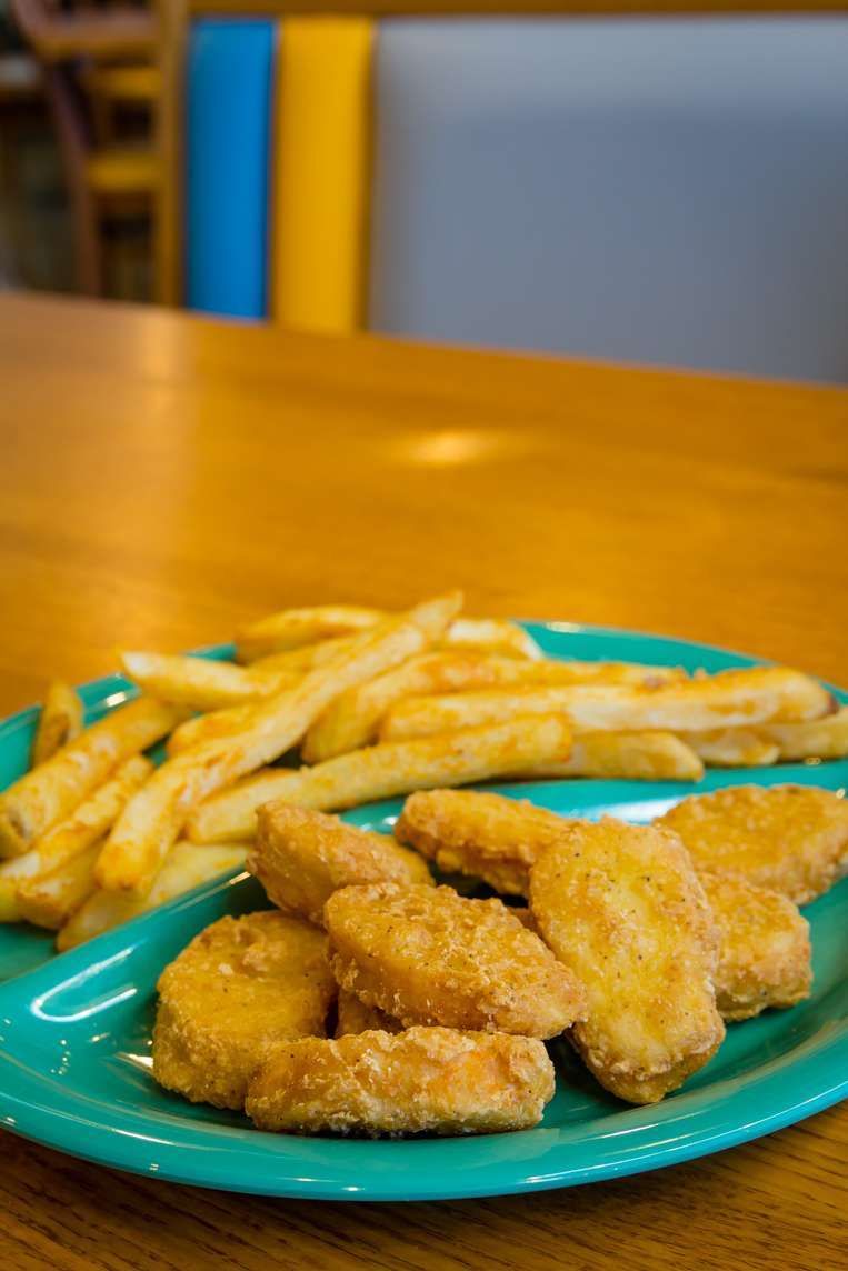 Hand-breaded chicken strips with fries
