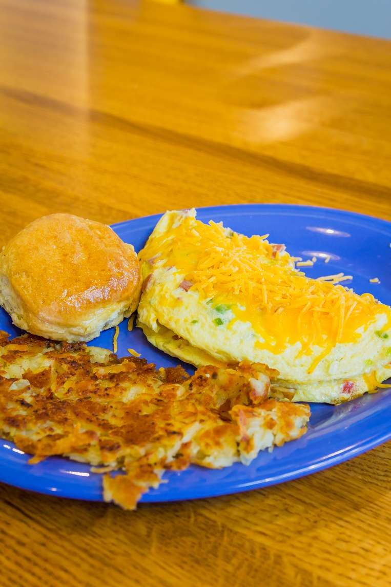 Cheese omelet with hash browns and biscuit
