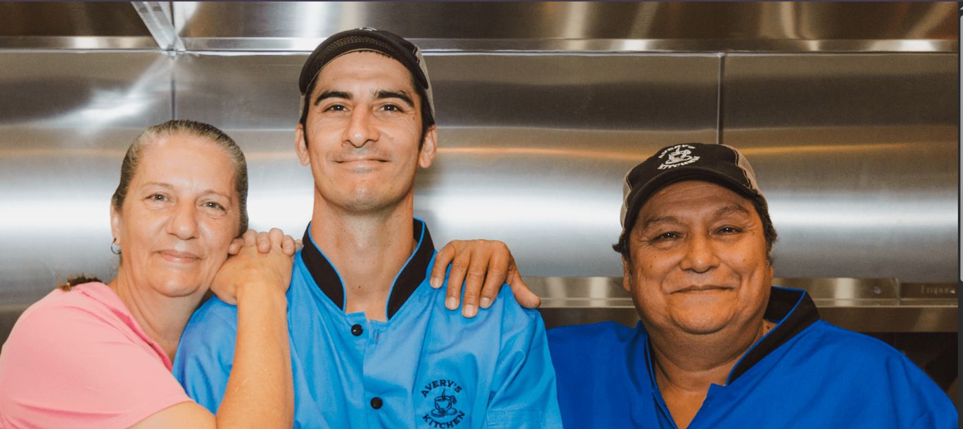 Three members of the Avery's Kitchen team smiling in the kitchen